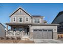 Two-story house with gray siding, attached garage, and a charming front porch at 13267 E 108Th Ave, Commerce City, CO 80022