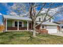 Charming two-story home featuring a manicured lawn, brick accents, and a welcoming front porch at 4555 E 121St Ct, Thornton, CO 80241