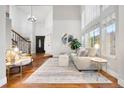 Bright and airy living room with high ceilings, hardwood floors, and large windows at 9871 Indian Wells Dr, Lone Tree, CO 80124