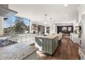 Bright kitchen with large windows, granite countertops, and a center island with seating at 23785 Currant Dr, Golden, CO 80401