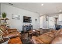 Spacious living room featuring hardwood floors, recessed lighting, and adjacent kitchen at 4128 Castle Vista Ln, Castle Rock, CO 80104