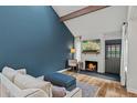 Cozy living room features a brick fireplace, vaulted ceiling, and stylish decor, perfect for relaxation at 14252 E Radcliff Cir, Aurora, CO 80015