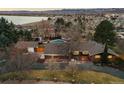 Beautiful aerial view of property and landscaping featuring a pool and lake in the background at 7382 W Stanford Ave, Littleton, CO 80123