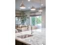 Kitchen island and sink with a great view of the backyard and opening to a living space at 2320 N Lafayette St, Denver, CO 80205