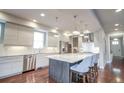 Modern kitchen with stainless steel appliances, center island with marble countertop, and hardwood flooring at 2320 N Lafayette St, Denver, CO 80205