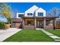 Stunning two-story home with a brick and siding facade, a covered porch, and manicured front lawn, showcasing curb appeal at 2732 S Jackson St, Denver, CO 80210