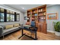 Stylish home office featuring a modern desk, built-in wooden shelving, and a comfortable seating area with natural light at 2732 S Jackson St, Denver, CO 80210