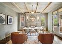Home office with fireplace, wood beams, and ample light at 1050 S Gilpin St, Denver, CO 80209