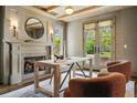 Home office with fireplace, wood beams, french doors and cozy chairs at 1050 S Gilpin St, Denver, CO 80209