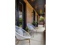 Covered porch with seating and black trim at 1050 S Gilpin St, Denver, CO 80209