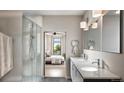 Contemporary bathroom with a double sink vanity, modern lighting fixtures, and a glass-enclosed shower at 1643 Boulder St # 211, Denver, CO 80211