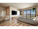 Living room features floor-to-ceiling windows offering city views, sleek furniture, and an open concept layout at 1643 Boulder St # 211, Denver, CO 80211