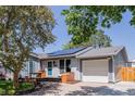 Charming single Gathering home with attached garage, landscaped yard, and solar panels on the roof at 2452 S Norfolk St, Aurora, CO 80013