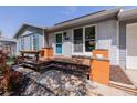 Charming front porch with blue door and wood accents, perfect for relaxing outdoors at 2452 S Norfolk St, Aurora, CO 80013