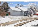 Street view of charming home with snowy yard, porch, gray exterior, and attached garage at 17794 E Bellewood Dr, Aurora, CO 80015