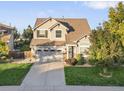 Beautiful two-story home with a well-kept lawn and a two-car garage on a sunny day at 9294 Melborne Ct, Parker, CO 80134