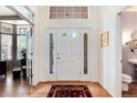 Bright foyer with hardwood floors, white trim, transom window, and a view of the study at 2959 W 110Th Pl, Westminster, CO 80234