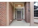 Close up of the front door with brick columns, transom window, and sidelights at 2959 W 110Th Pl, Westminster, CO 80234