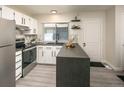 Updated kitchen with white cabinetry, stainless steel appliances, and a stylish marble backsplash at 7978 Chase Cir # E, Arvada, CO 80003