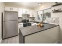 Modern kitchen featuring white cabinets, stainless steel appliances, and a sleek countertop at 7978 Chase Cir # E, Arvada, CO 80003