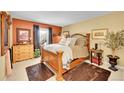 Comfortable bedroom featuring a cozy bed with wood frame, with stylish rustic accents and inviting natural light at 2301 E Fremont Ave # W02, Centennial, CO 80122