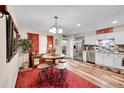 Bright kitchen and dining area featuring stainless steel appliances, stylish backsplash, and wood-look flooring at 2301 E Fremont Ave # W02, Centennial, CO 80122