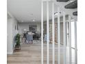 Stylish living room featuring neutral tones, modern furnishings, and hardwood floors with view to stairs at 15045 E Louisiana Dr # B, Aurora, CO 80012