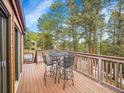 Enjoy outdoor dining on this spacious wooden deck with four chairs and scenic views at 23485 Bluestem Dr, Golden, CO 80401