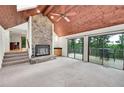Inviting living room with stone fireplace, wood ceiling, and sliding glass doors to outside deck at 23485 Bluestem Dr, Golden, CO 80401