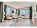 Inviting living room with large windows, comfortable seating, and stylish decor at 495 Bennett Ave, Bennett, CO 80102