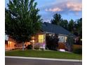 Beautiful landscaped lawn and garden beds surround this lovely home with its welcoming covered front porch at 1762 Granger Cir, Castle Rock, CO 80109