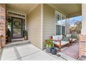 Cozy front porch with comfortable seating and decorative plants, perfect for relaxing outdoors at 1762 Granger Cir, Castle Rock, CO 80109