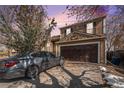 Two-story home features an attached garage and a well-maintained lawn at 2986 S Fundy Ct, Aurora, CO 80013