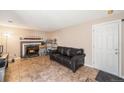 Cozy living room featuring a fireplace, tile flooring, and a comfortable couch at 2986 S Fundy Ct, Aurora, CO 80013