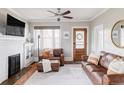Cozy living room featuring a decorative fireplace, wooden floors, and comfortable leather seating at 680 S Ogden St, Denver, CO 80209