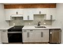 Updated kitchen with white cabinets, quartz countertops, stainless appliances, and stylish backsplash for a modern look at 2500 S York St # 204, Denver, CO 80210