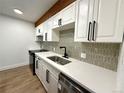 Modern kitchen featuring stainless steel appliances and quartz countertops, accented by a decorative backsplash at 2500 S York St # 204, Denver, CO 80210