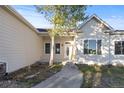 Well-maintained home featuring a concrete walkway leading to a white front door with an oval glass window at 34427 Columbine W Trl, Elizabeth, CO 80107
