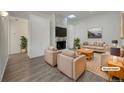 Cozy living room featuring a stone fireplace, plush seating, and modern decor for relaxation at 927 E 7Th Ave, Broomfield, CO 80020