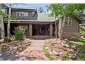 Inviting front entrance with covered porch and well-manicured landscaping at 1570 Blakcomb Ct, Evergreen, CO 80439
