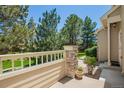 Home's exterior boasts mature trees and a fence surrounding the front yard, enhancing privacy and curb appeal at 9522 Silver Spur Ln, Highlands Ranch, CO 80130