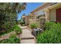 A well maintained walkway with shrubs and landscaping leads to the charming house at 9522 Silver Spur Ln, Highlands Ranch, CO 80130