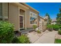 Charming home with a well-kept front yard, landscaped entrance, and a welcoming walkway at 9522 Silver Spur Ln, Highlands Ranch, CO 80130