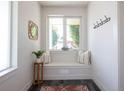 Bright entryway with seating nook, large window, and decorative mirror at 2197 S Clermont St, Denver, CO 80222