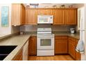 Spacious kitchen boasts wooden cabinets, granite counters and stainless steel appliances at 6468 S Hudson St, Centennial, CO 80121