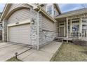 Beautiful home featuring a cozy front porch, two car garage, and well maintained landscaping at 21562 Omaha Ave, Parker, CO 80138
