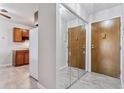 Condo entryway featuring mirrored closet doors, tile flooring, and access to the kitchen at 9155 E Center Ave # 3C, Denver, CO 80247