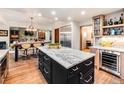 Spacious kitchen with center island, stainless steel appliances, open to dining area and fireplace at 62 N Ranch Rd, Littleton, CO 80127