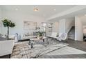Inviting living space featuring neutral tones, stylish furniture, and a cozy rug at 15252 W 69Th Pl, Arvada, CO 80007