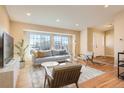 Bright living room features hardwood floors, large windows, and neutral tones at 805 Northridge Rd, Highlands Ranch, CO 80126